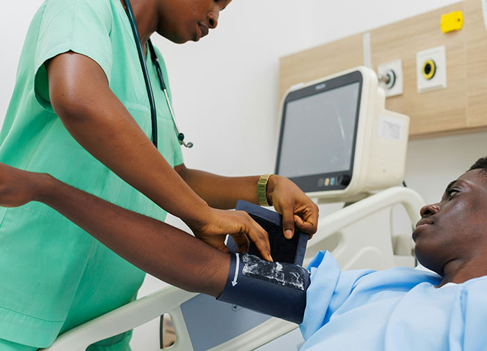 Nurse checking blood pressure of a patient in hospital, highlighting worst things patients had to go through experiences.