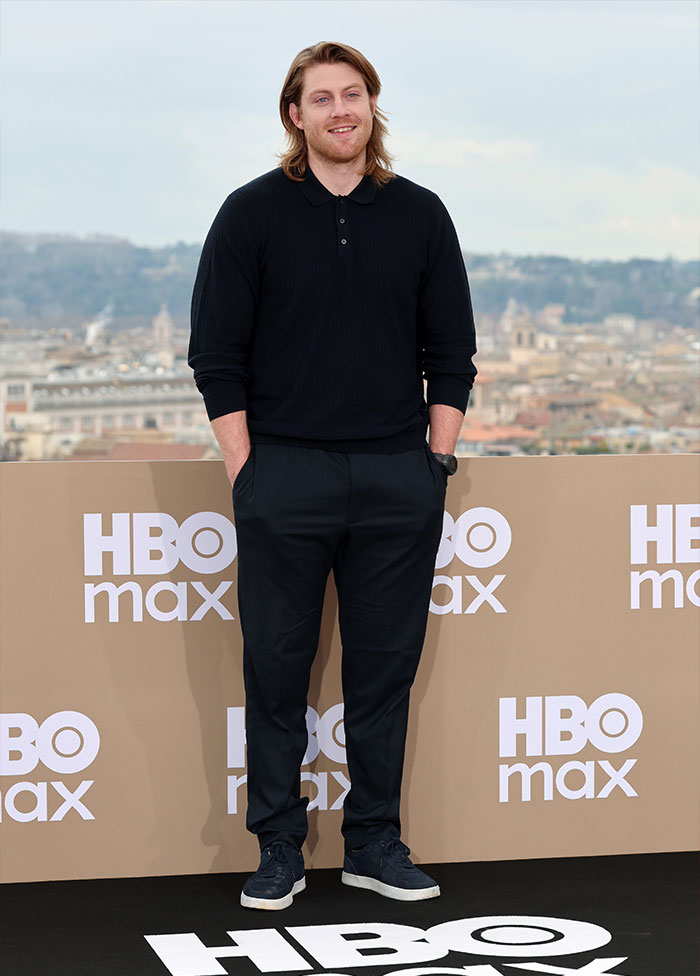 Peter Claffey standing casually in black outfit at an HBO Max event, fans react to critic's comment about his body.