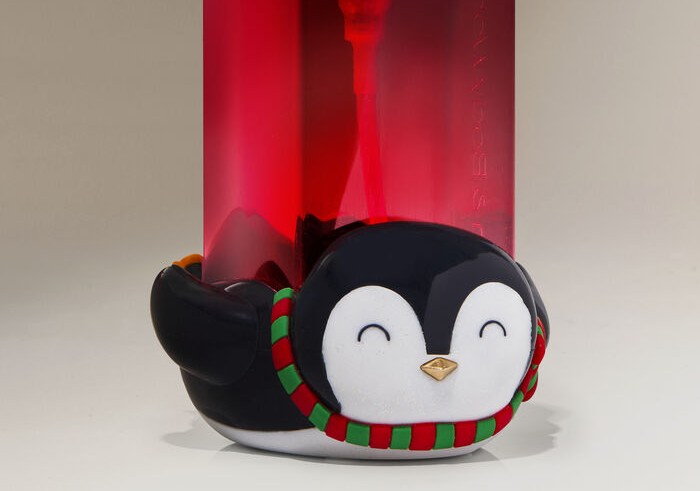 Close-up of a smiling penguin bottle holder in red and green colors, capturing ridiculous moments people thought were pranked.