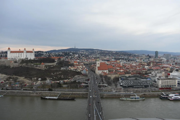 Cityscape with historic buildings and river bridge showcasing one of the best countries to raise a family according to UNICEF.