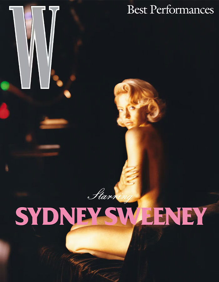 Celebrity photoshoot woman posed n**e covering chest, blonde hair in vintage waves, dramatic low-key lighting on dark set