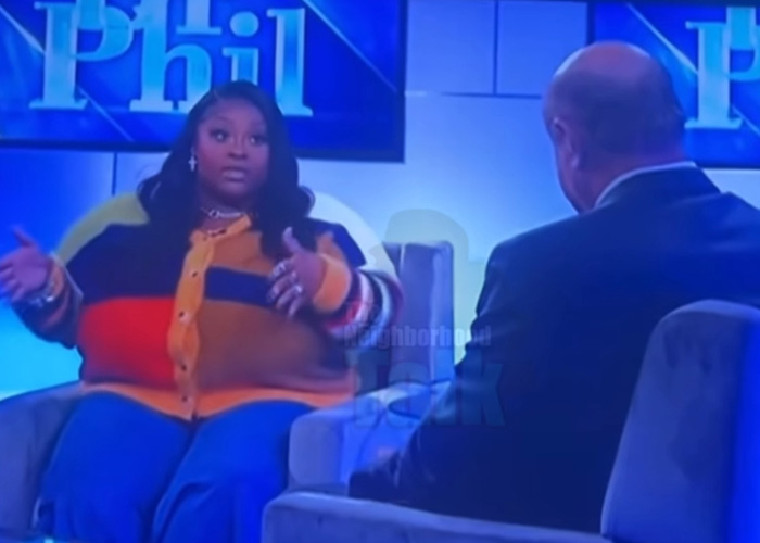 TikTok influencer in colorful sweater discussing $1.75 million debt after admitting inappropriate act on talk show set.