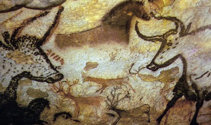 Ancient cave paintings of animals on a textured rock wall in one of the forbidden places on Earth.