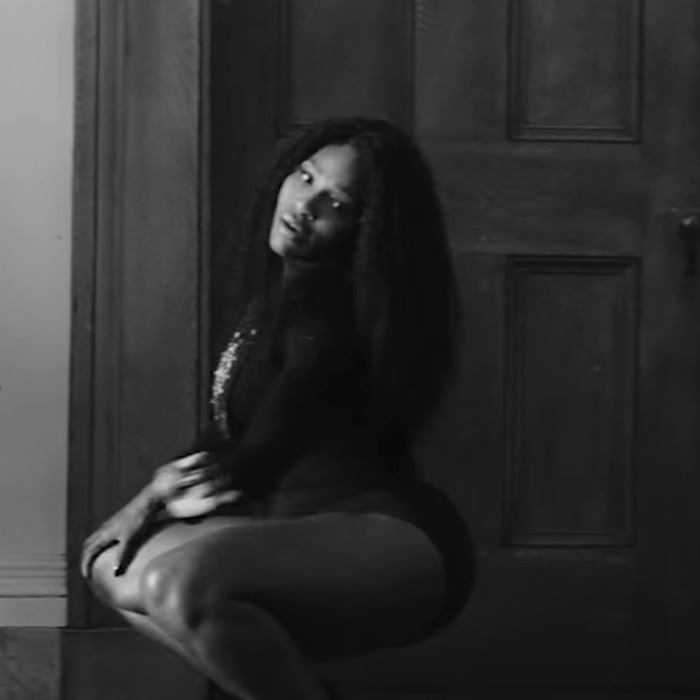 Serena Williams in a dramatic pose showcasing knees kneeing move with intense expression against a wooden door background.