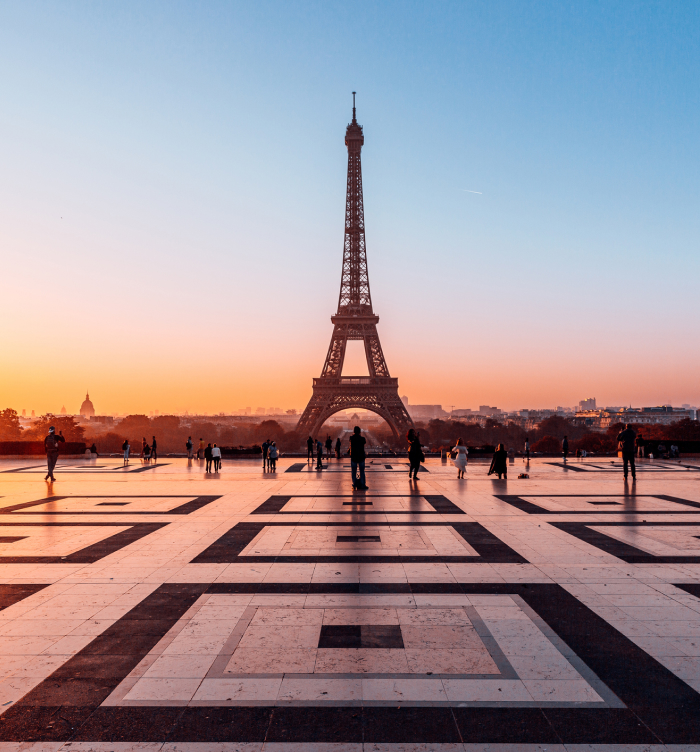 Eiffel Tower at sunset with people in foreground, representing one of the oldest countries in the world.