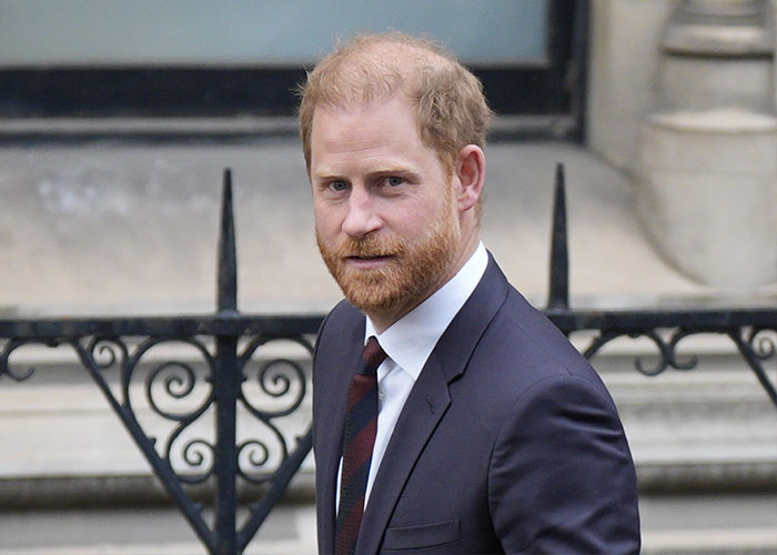 Prince Harry outside court in a dark suit, attending trial connected to emotional accusations involving Liz Hurley.