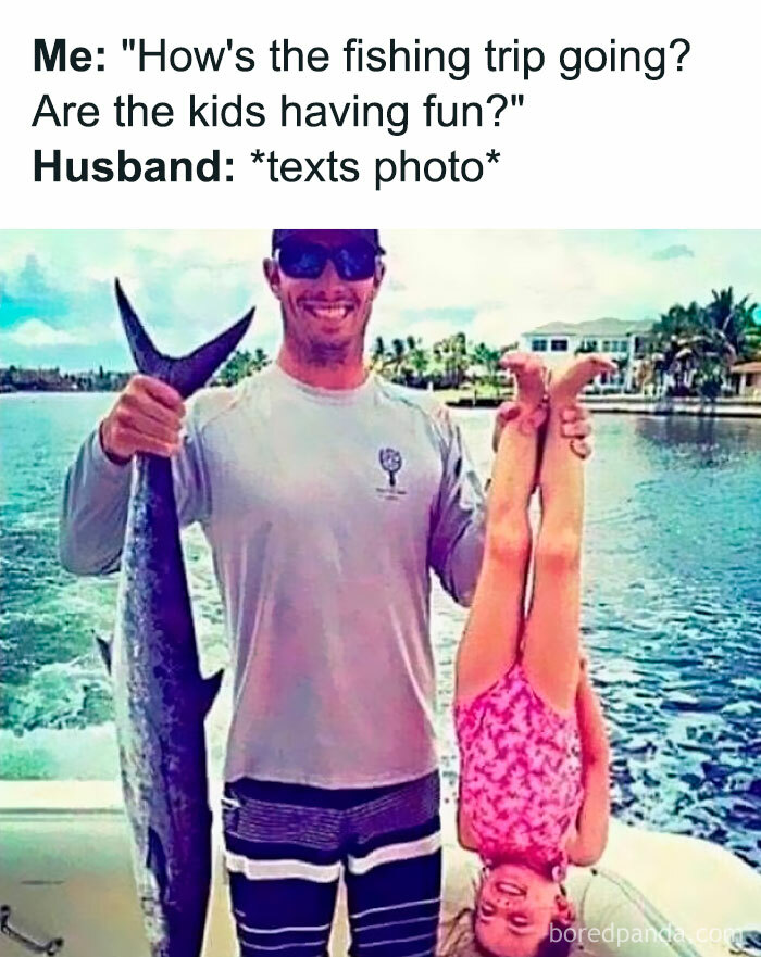 Man holding large fish and daughter upside down on boat, showcasing funny dad joke humor from fishing trip photos.