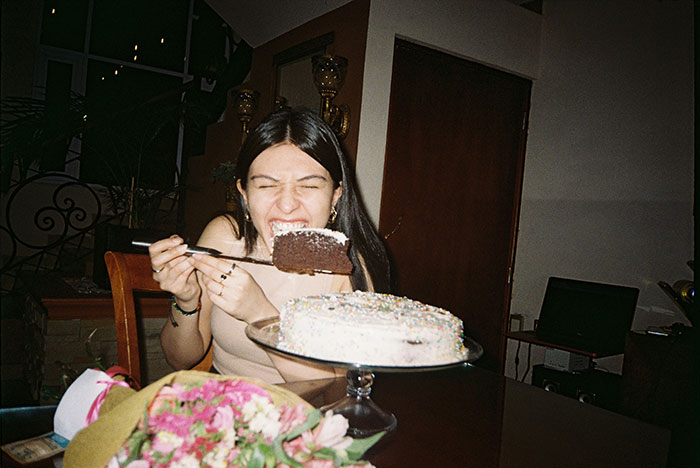 Woman eating a chocolate cake slice, representing a man eating pregnant partner&rsquo;s craving treat and their relationship struggles.