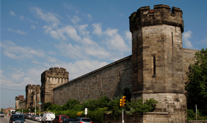 Stone fortress with towers along a busy street, representing one of the most haunted places in America.