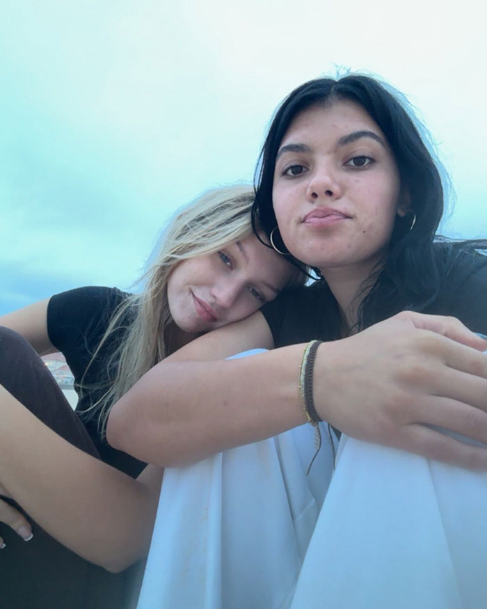 Two young women outdoors with one resting her head on the other's shoulder, related to autopsy results and dingoes case.