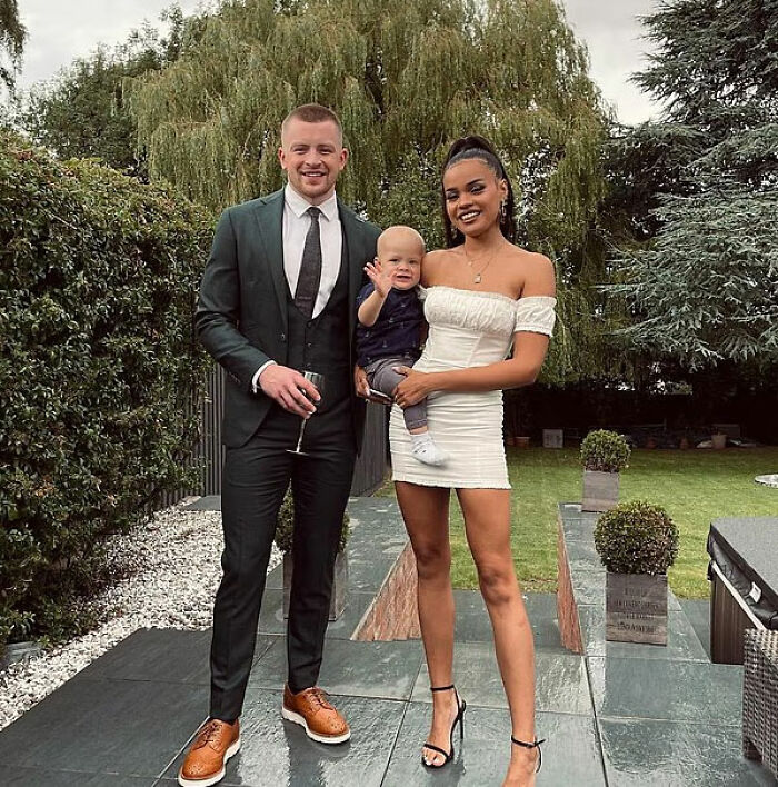 Adam Peaty with partner and child outdoors, linked to controversial wedding and name change news.