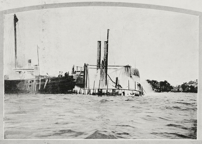 Black and white photo of a partially submerged steamboat, a haunted place with dark secrets in America.