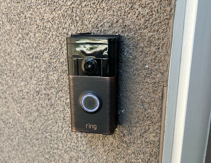 Smart video doorbell mounted on exterior wall as a security measure women use to feel safer living alone.