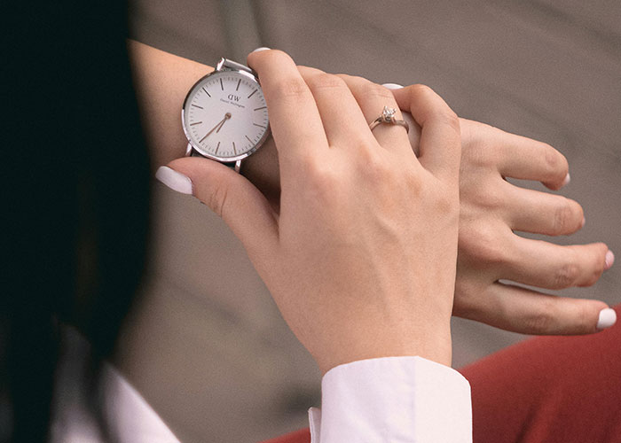 Close-up of a person adjusting a wristwatch, highlighting habits neurodivergent people thought were normal.