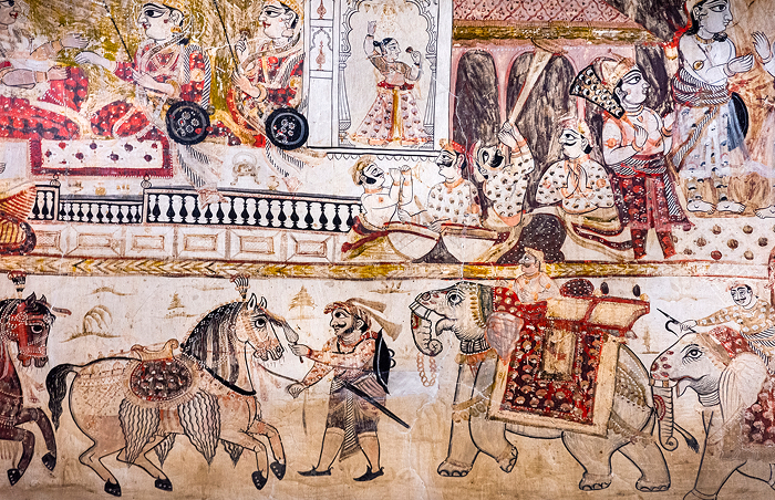 Ancient mural depicting historic scenes with horses, elephants, and people, representing oldest countries in the world.