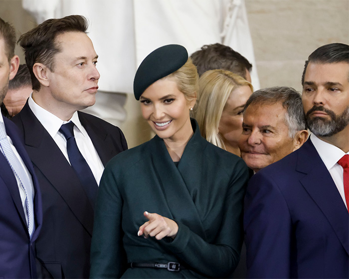 Group of people at a formal event, with a woman in a green outfit and a man in a dark suit, related to Epstein victim claims.