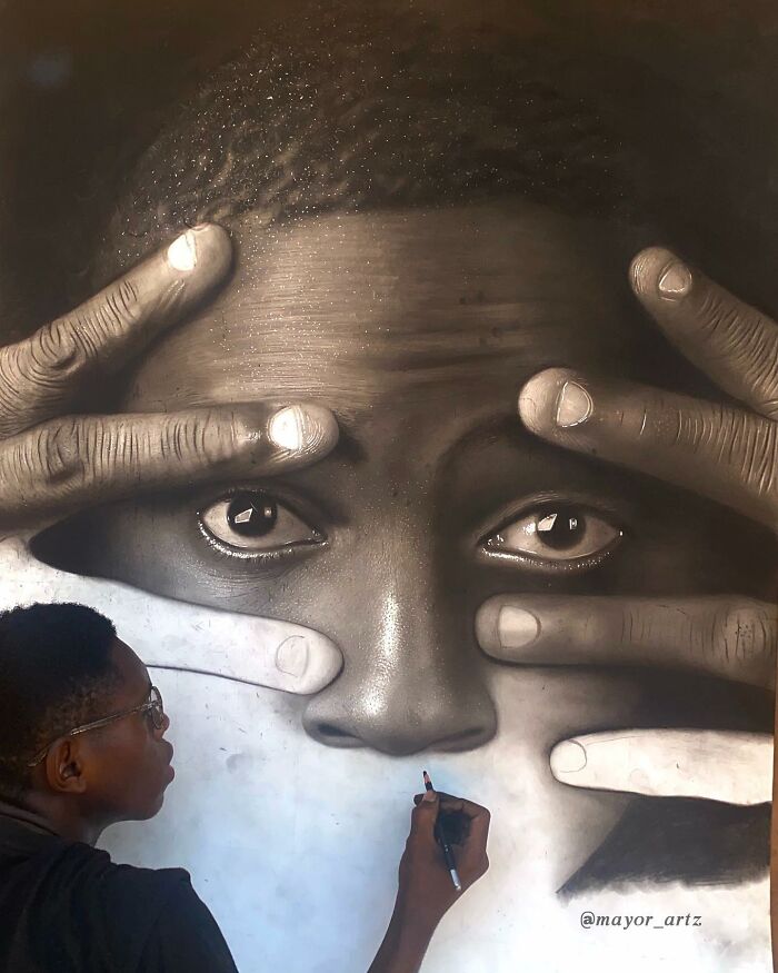 Artist creating a hyperrealistic portrait, focusing on detailed facial features and hands in monochrome tones.