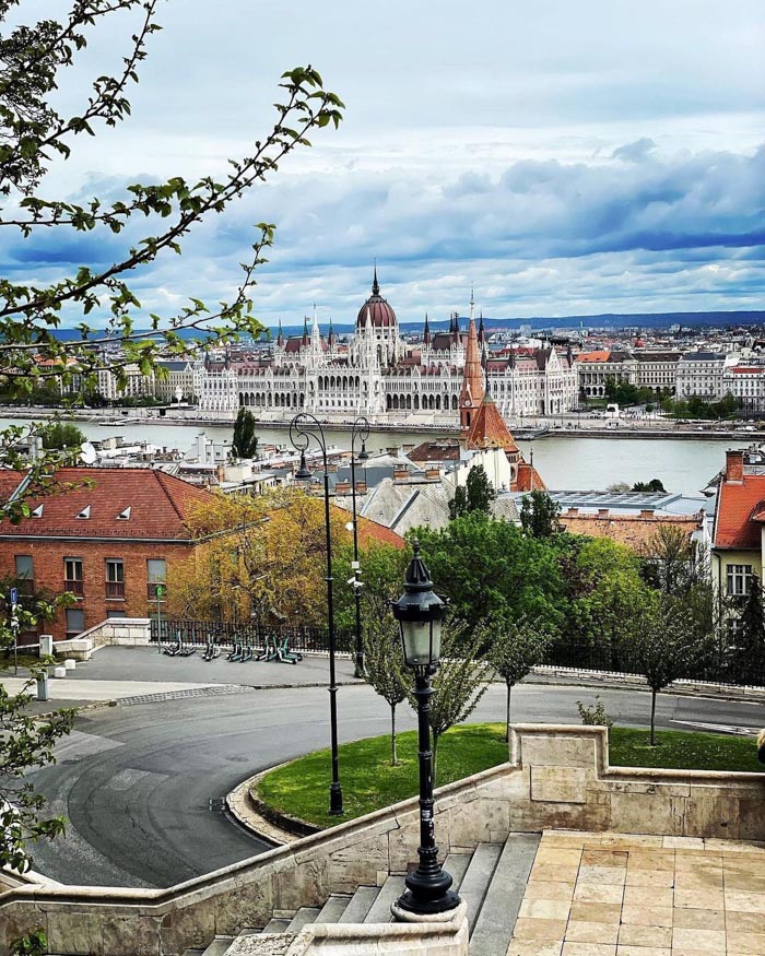 Panoramic cityscape showing historic buildings and river, illustrating countries that sleep the most with OECD time use data.