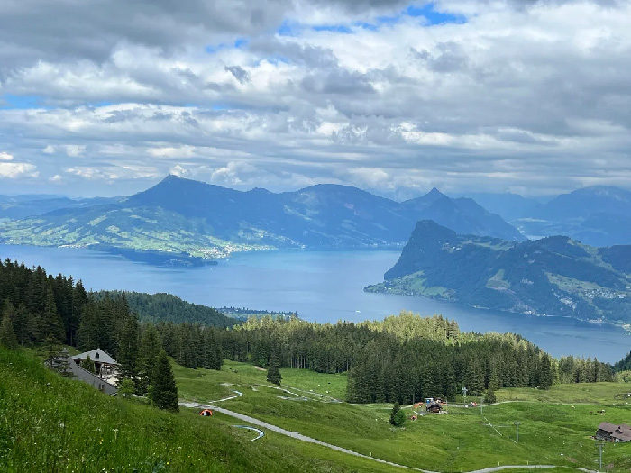 Scenic landscape of lush greenery and mountains by a lake, illustrating best countries to raise a family environment.