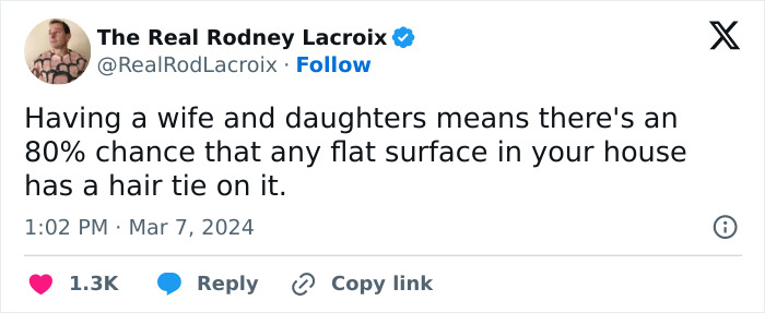 Tweet by The Real Rodney Lacroix humorously about dads and husbands relating to hair ties on flat surfaces at home.