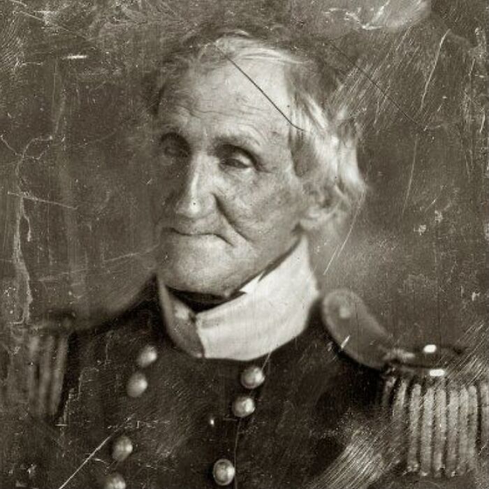 Sepia-toned historical photograph of an elderly military officer showing the sad and beautiful history of humanity.