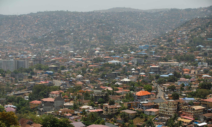 Aerial view of a densely populated hillside city, representing Most Stressful Countries and urban crowding