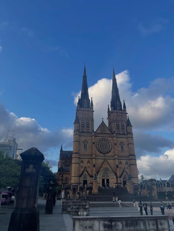 Gothic cathedral under blue sky, representing countries that sleep the most in OECD time use data analysis.