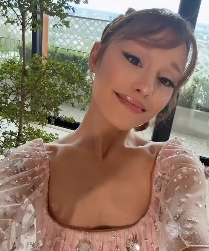 Ariana Grande posing in a pink embellished dress with makeup, involved in a red carpet controversy with Leighton Meester. Ariana Grande posing in a pink embellished dress with makeup, involved in a red carpet controversy with Leighton Meester.