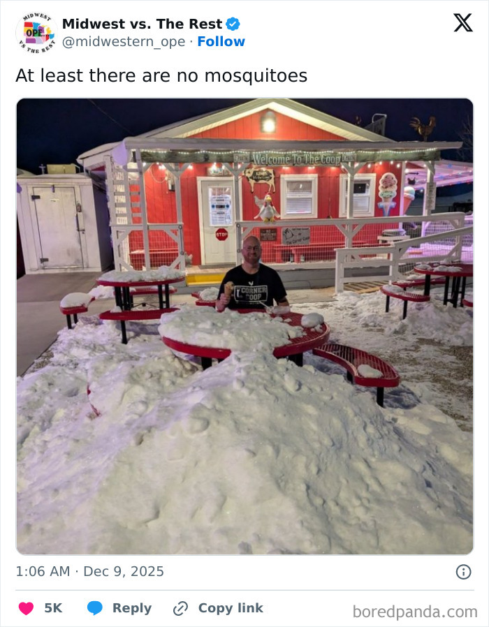 Man sitting at snow-covered picnic tables outside a brightly lit red building in Midwest life meme scene.