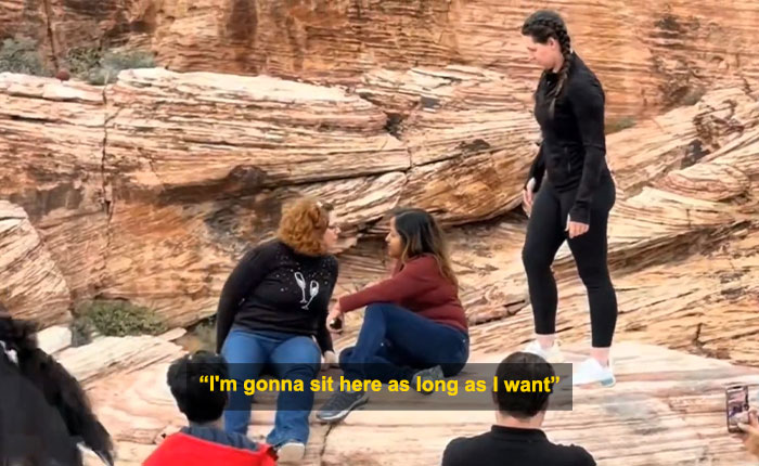 Woman blocks tourist&rsquo;s shot at Red Rock Canyon while sitting on rocks, causing a viral Karen of 2026 incident.