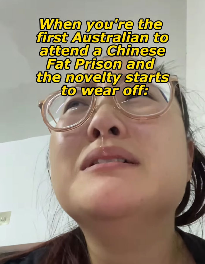 Close-up of a woman wearing glasses with a distressed expression describing conditions in a Chinese fat prison.