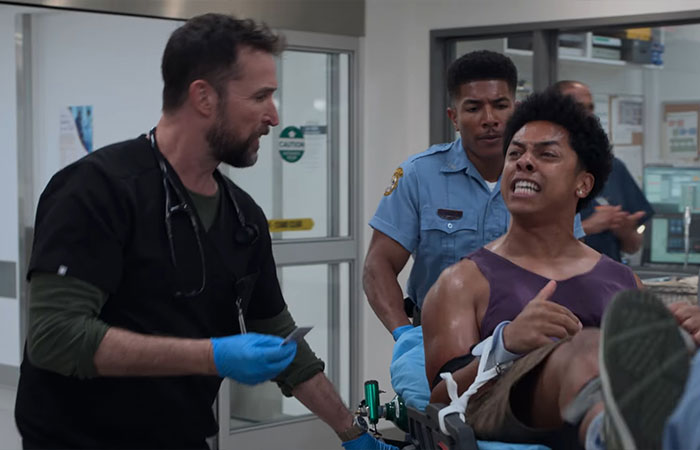 Man in distress on stretcher with medical staff attending, related to 2901 meaning in The Pitt season 2 episode 2 ending.