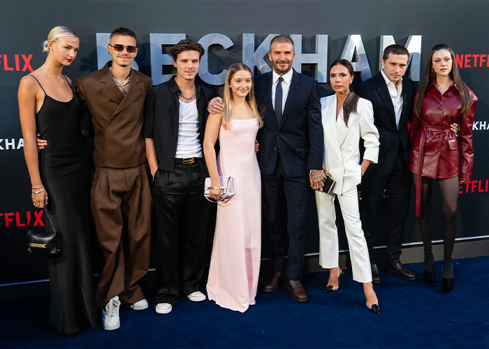 Nicola Peltz posing with the Beckham family at a red carpet event, highlighting the family photo moment.