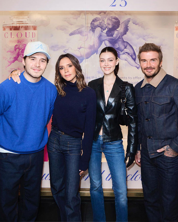 Brooklyn Beckham and David Beckham posing with Victoria Beckham and a woman at a promotional event.
