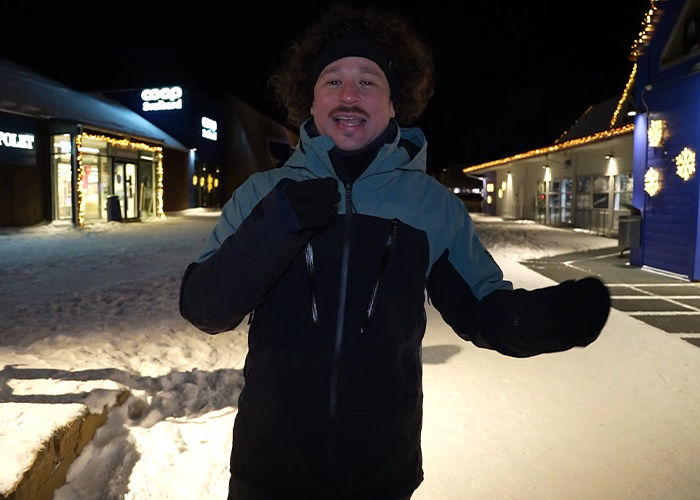 Content creator standing outside at night on the world&rsquo;s darkest island, dressed warmly in winter clothing.