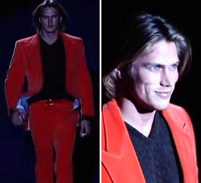 Male model in a red suit on runway, part of viral Gucci comparison video on male models in 1995 and 2025 trends.