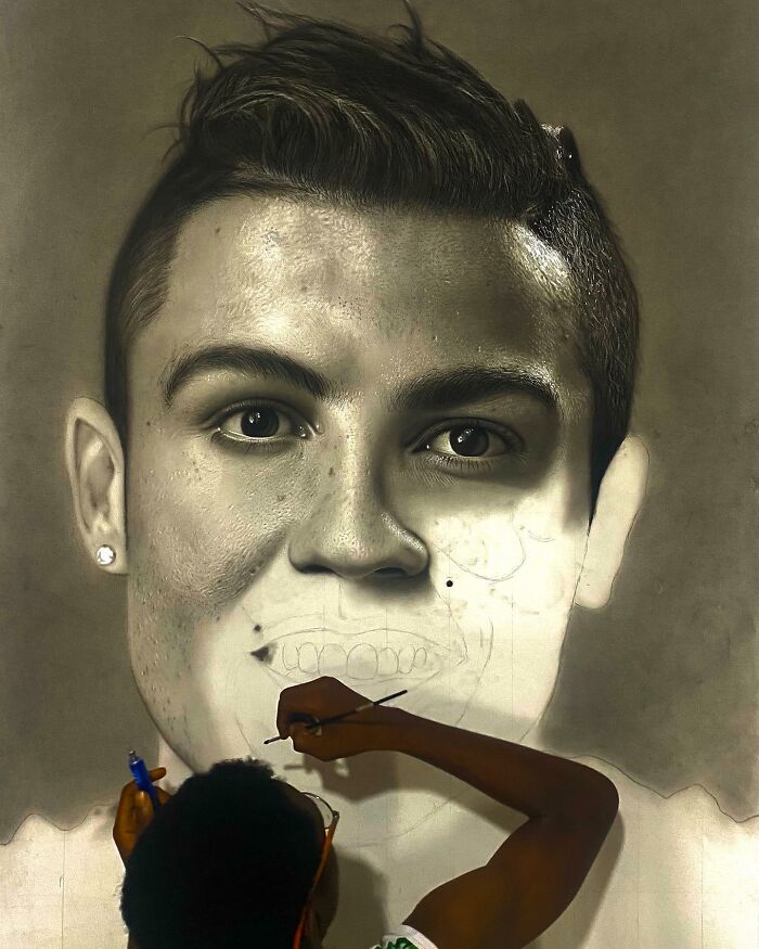 Artist creating a hyperrealistic portrait, showing detailed facial textures and drawing process behind the scenes.