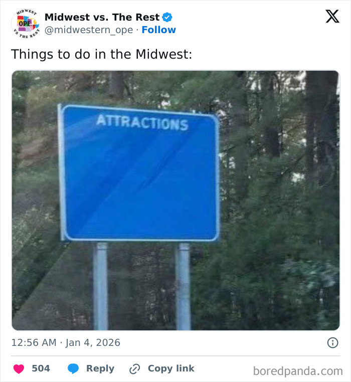 Blank blue road sign labeled Attractions in a forested area, illustrating spot-on Midwest life memes about corn cravings.