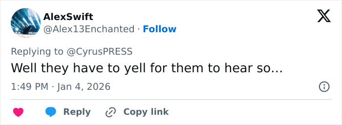 Tweet reply on social media discussing Miley Cyrus pushing back at photographers during tense red carpet encounter.