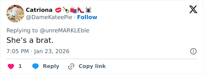 Screenshot of a tweet showing a reply reading she&rsquo;s a brat amid Victoria Beckham and Nicola Peltz feud going viral.