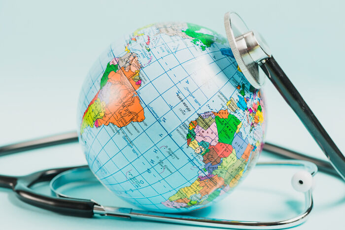 Stethoscope placed on a globe symbolizing uplifting stories of progress and hope in America beyond negative headlines