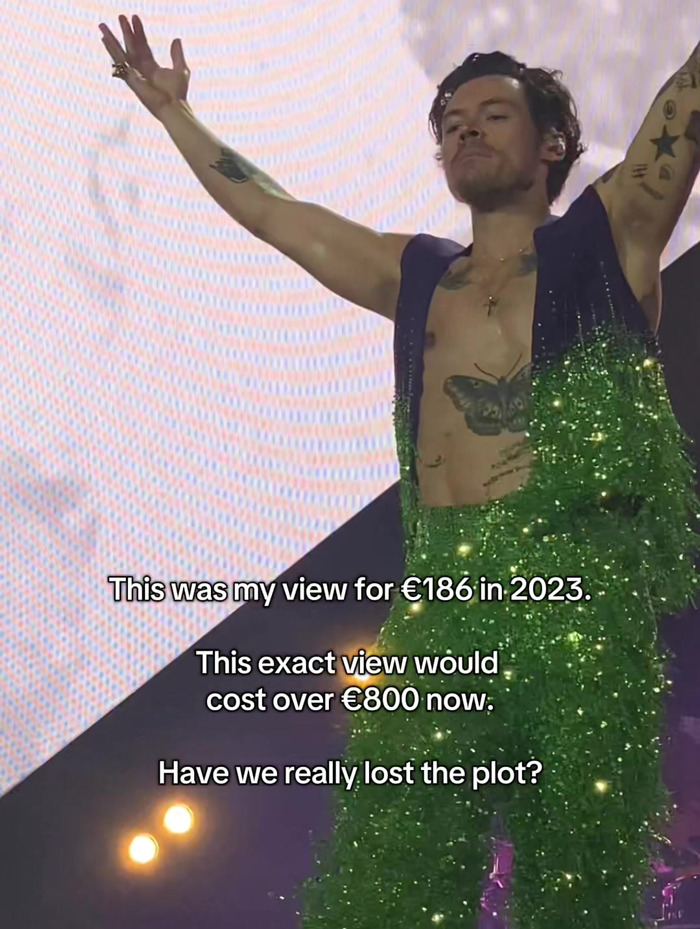Harry Styles performing on stage with fans outraged at the high prices of his new tour tickets in 2023.