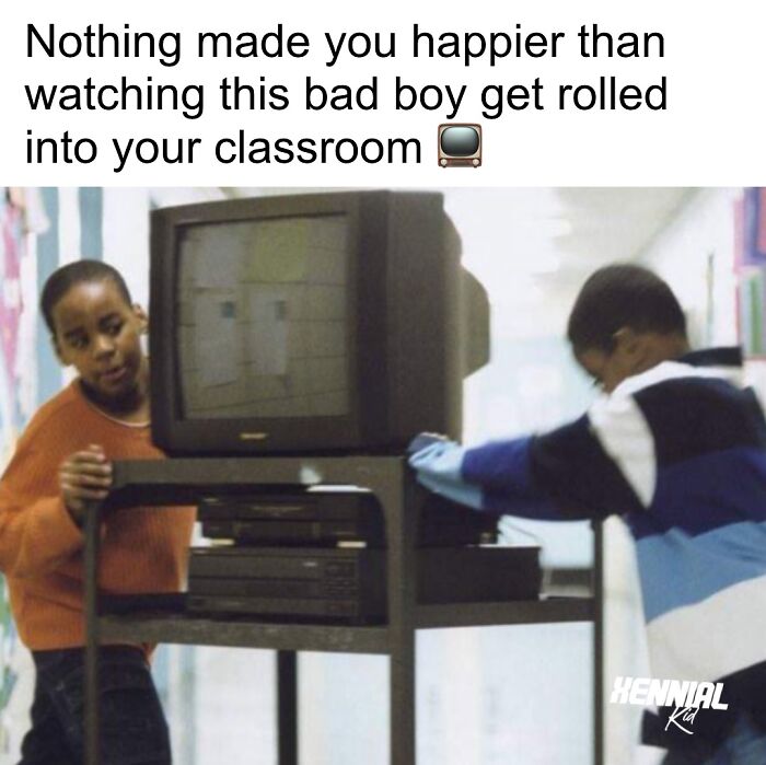Two kids pushing an old TV cart down a school hallway, sparking nostalgic memories for Xenials.