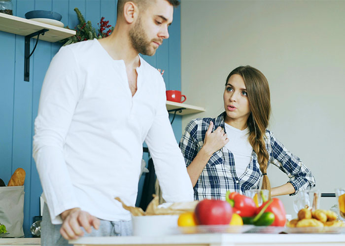 Dad and daughter having a tense conversation in kitchen, highlighting gift disparity between daughter and half-brother at Christmas. Dad and daughter having a tense conversation in kitchen, highlighting gift disparity between daughter and half-brother at Christmas.