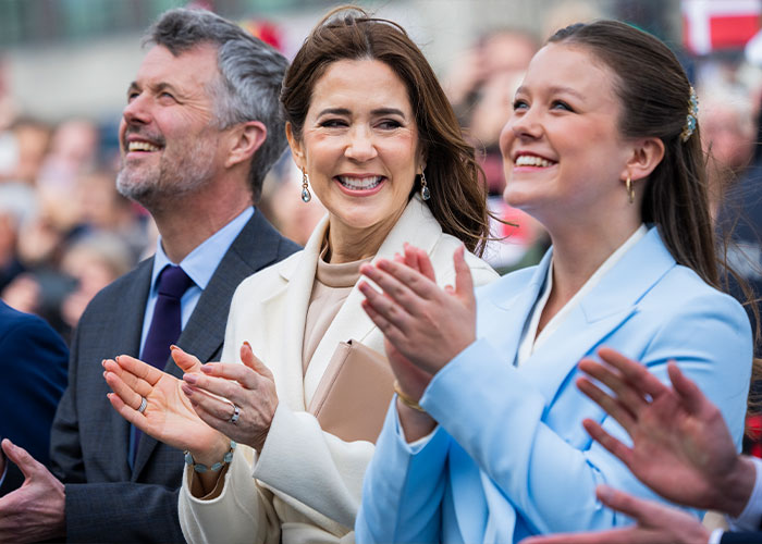 Smiling princess and attendees clapping at a public event related to Barron Trump and Princess Isabella marriage discussion.