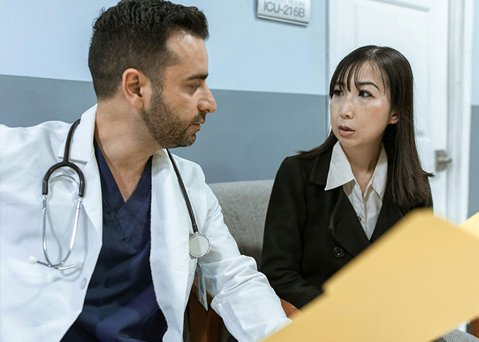 Doctor and patient having a serious conversation in a medical office highlighting worst things medical professionals say.