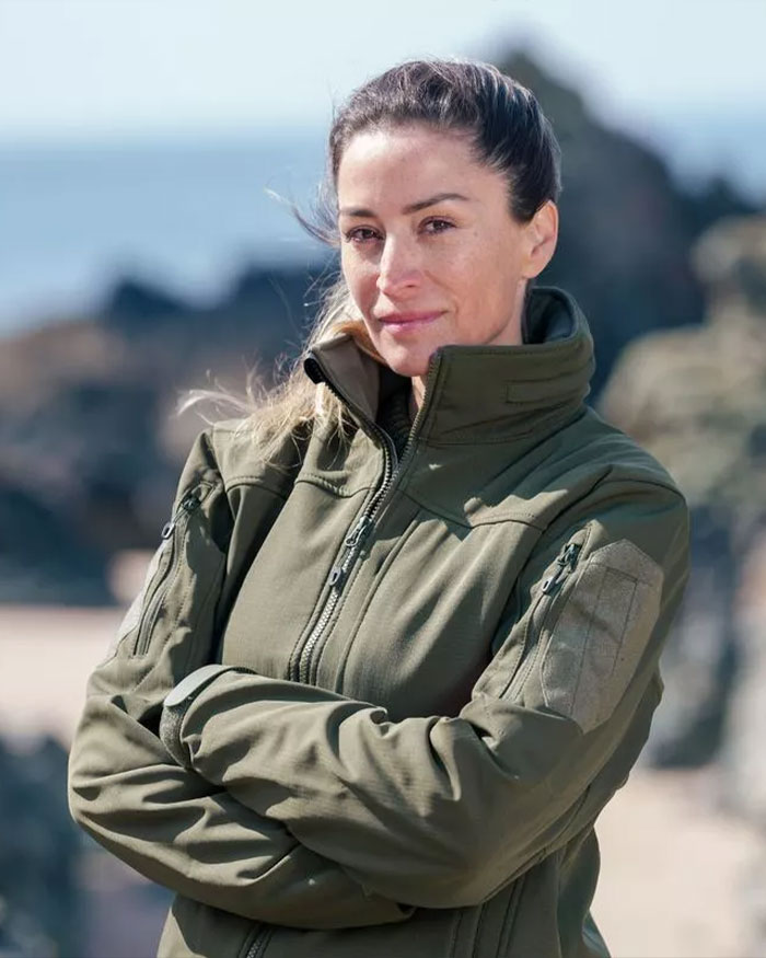 Woman in an olive green jacket outdoors, representing David Beckham&rsquo;s ex-assistant reacting to Brooklyn Beckham&rsquo;s family rift.