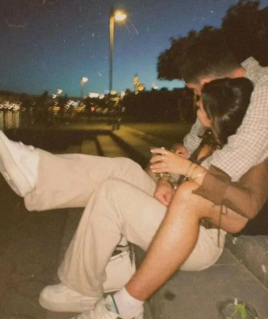 Couple sitting outdoors at night sharing a moment, perfect for fun questions to ask your partner and connect deeply.