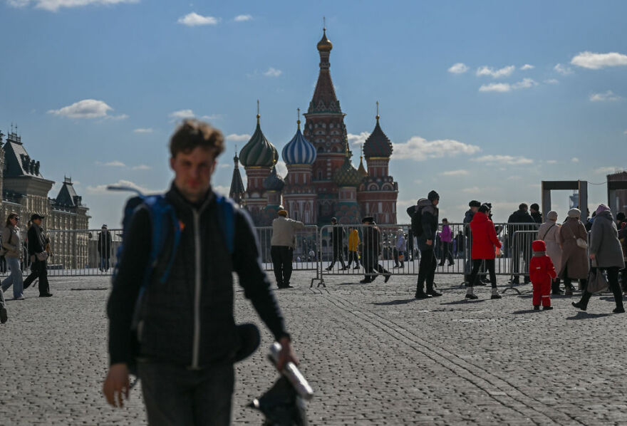 People walking near Saint Basil\'s Cathedral in Red Square, representing 15 nations setting new global standards for paid leave.