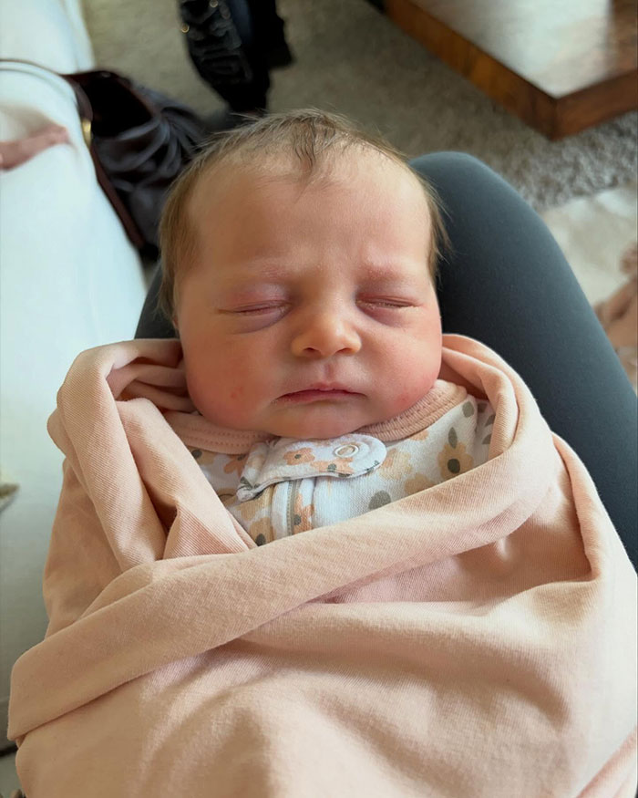 Newborn baby peacefully sleeping, wrapped in a pink blanket, reflecting Meghan Trainor surrogate baby news. Newborn baby peacefully sleeping, wrapped in a pink blanket, reflecting Meghan Trainor surrogate baby news.